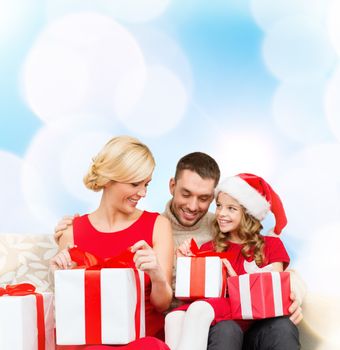 family, christmas, x-mas, winter, happiness and people concept - happy family opening