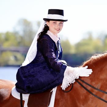 Lady on a  horse. The lady on riding walk. Portrait of the horsewoman. The woman astride a horse. The aristocrat on riding walk.