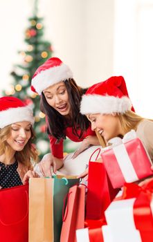 shopping, sale, gifts, christmas, x-mas concept - smiling women in santa helper hats with shopping bags and many gift boxes