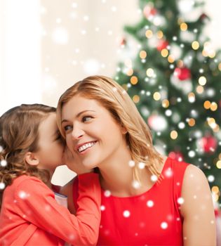 christmas, x-mas, winter, happiness concept - mother and daughter whispering gossip