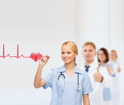 healthcare, medical and technology - young doctor or nurse drawing electrocardiogram