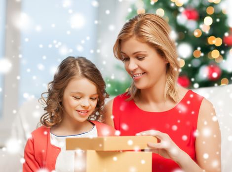 holidays, presents, christmas, x-mas, birthday concept - happy mother and child girl with gift box