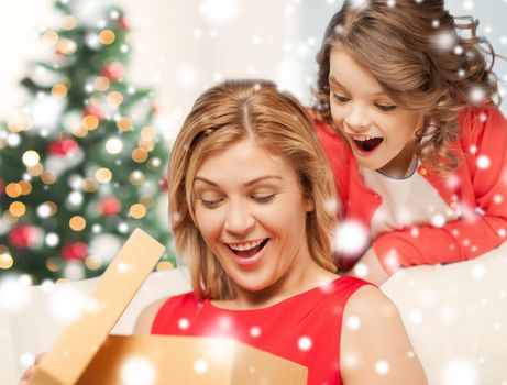 holidays, presents, christmas, x-mas, birthday concept - happy mother and child girl with gift box