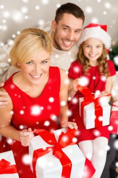 family, christmas, x-mas, winter, happiness and people concept - happy family opening gift boxes