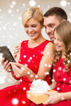 family, christmas, x-mas, winter, happiness, technology and people concept - smiling family with tablet pc