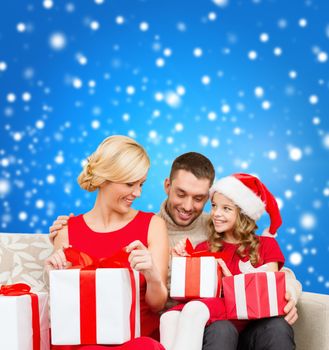 family, christmas, x-mas, winter, happiness and people concept - happy family opening gift boxes