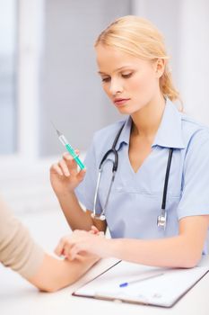 healthcare and medicine concept - calm female doctor or nurse doing injection to patient