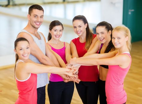 fitness, sport, training, gym, success and lifestyle concept - group of happy people in the gym celebrating victory