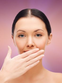 spa, health and beauty concept - beautiful woman covering her mouth