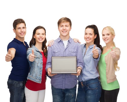 education, advertisement and new technology concept - smiling students with laptop computer blank screen showing thumbs up