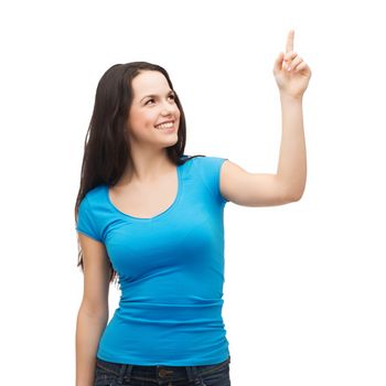 advertisement concept - attractive teenager in casual clothes pointing her finger up