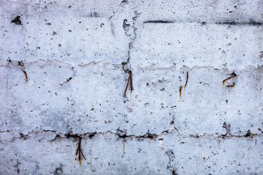 Grey concrete surface with the hardened traces of the shuttering moulds