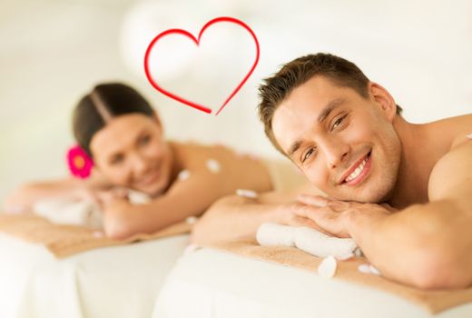 spa, beauty, love and happiness concept - smiling couple lying on massage table in spa salon