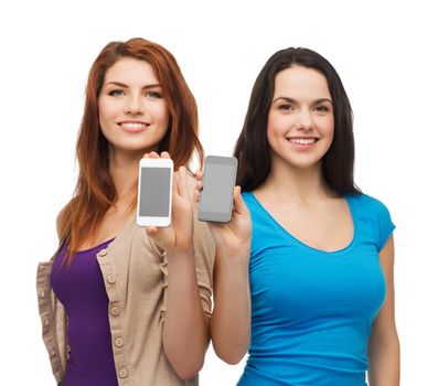 education and modern technology concept - smiling students showing blank smartphones screens