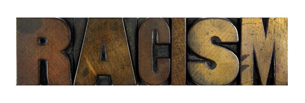 The word RACISM written in vintage letterpress type