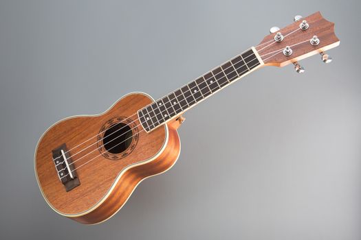 Studio shot of ukulele guitar on gray background 