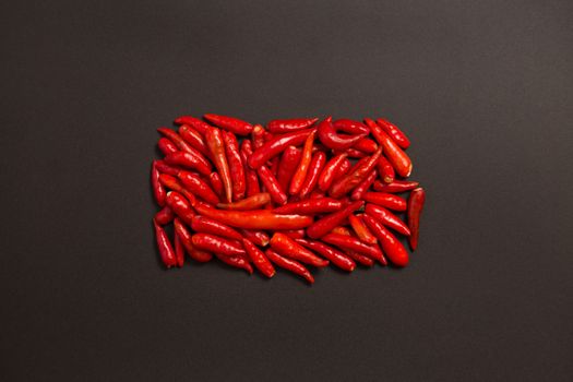 Non-stem red bird eye chili pepper on grey background 