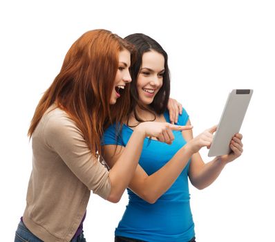 technology, friendship and people concept - two smiling teenagers pointing finger at tablet pc screen