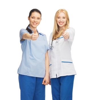 healthcare and medical concept - two doctors showing thumbs up