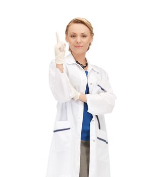 healthcare and medical concept - smiling female doctor pointing her finger up