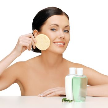 picture of woman with sponge and cosmetic bottles