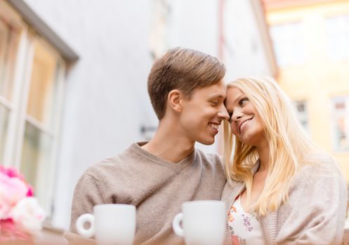 summer holidays, love, travel, tourism, relationship and dating concept - romantic happy couple in the cafe