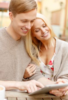 summer holidays, city, dating and technology concept - smiling couple with tablet pc computer in cafe