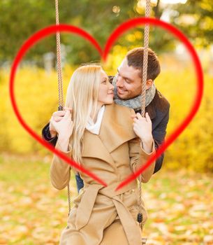 holidays, love, travel, tourism, relationship and dating concept - romantic couple in the autumn park