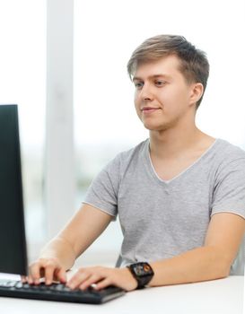 office, business, education, technology and internet concept - smiling student with computer