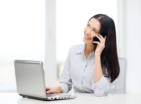 business and education concept - businesswoman with laptop and cell phone