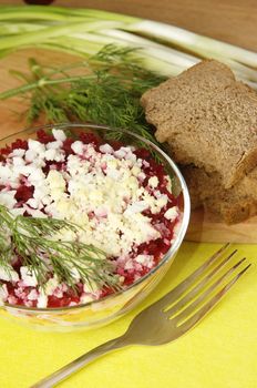 Russian traditional herring salad in glass bowl