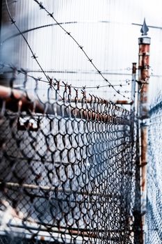 Spiky Barb Wire and Rusty Outdoor Fence