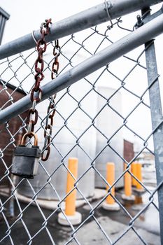 Gray fence and Rusty Hanging Lock Concept