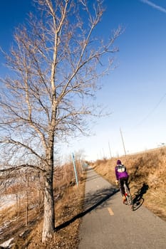 Bike Path and a unrecognizable biker during the Spring