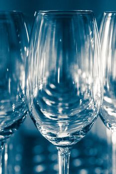 Many Empty Wineglasses Upside Down on a White reflective Table
