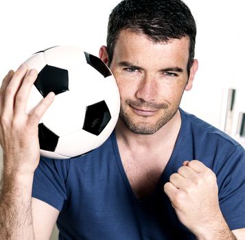 closeup of passionate soccer player with white and black balloon