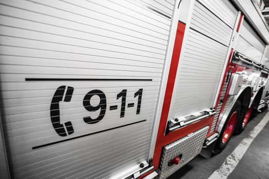 Red Firetruck Details of the Side and of the 911 telephone Sign