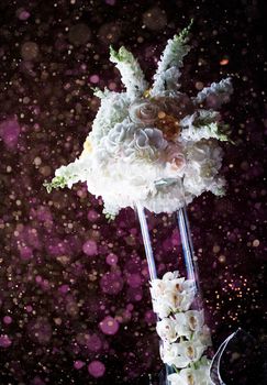 Beautiful Wedding Table Centerpiece Vase and Flowers with Pink bokeh in Background