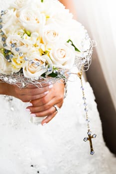 Bride Holding her Roses Bouquet and Rosary Close-up