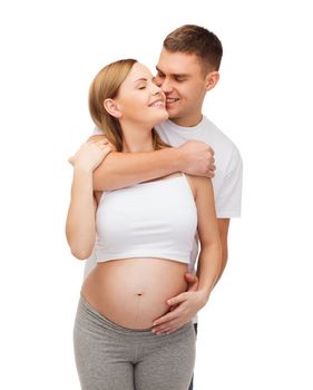 pregnancy, parenthood and happiness concept - happy young family expecting child