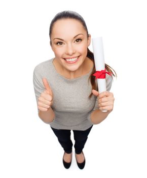 university and education concept - smiling woman with diploma showing thumbs up