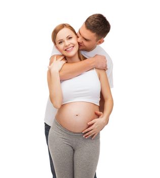 pregnancy, parenthood and happiness concept - happy young family expecting child