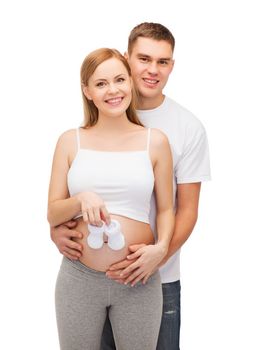 pregnancy, parenthood and happiness concept - happy young family expecting child