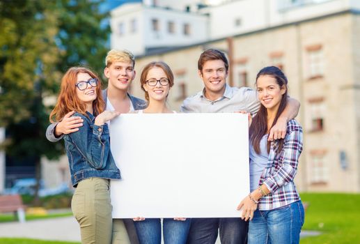 summer holidays, advertisement, education, campus and teenage concept - group of students or teenagers with white blank board