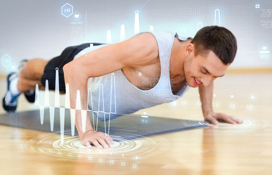 fitness, sport, training, gym and lifestyle concept - smiling man doing push-ups in the gym