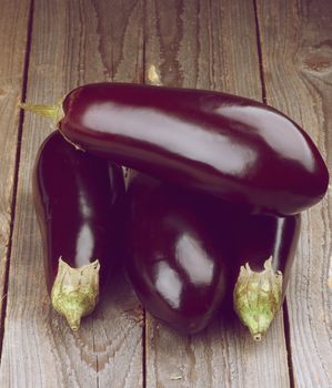 Stack of Fresh Ripe Eggplants isolated on Rustic Wooden background