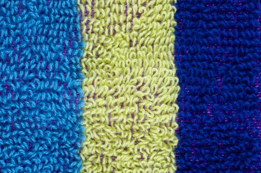 Striped Background of Navy Blue, Light Green and Blue Fluffy Cotton Rows closeup