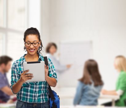 education, technology and people concept - smiling female african american student in eyeglasses with tablet pc and bag