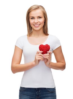 happiness, health and love concept - smiling woman in white t-shirt with heart