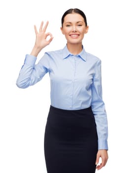 business and education concept - friendly young smiling businesswoman showing ok sign